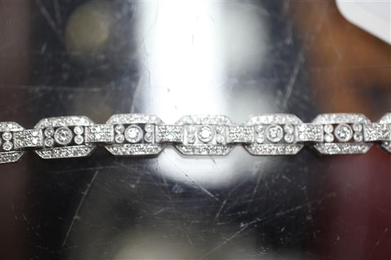 An Art Deco style 18ct white gold and diamond set octagonal link bracelet, 18.5cm.